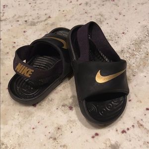 Nike toddler black and gold slides